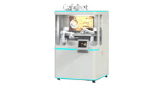 Load image into Gallery viewer, A white, box-shaped Dual-Arm Robotic Coffee Station by Elite Robots (Enclosed Type) from Useabot features robotic arms in a glass enclosure and a digital display with a coffee cup, offering self-service coffee.
