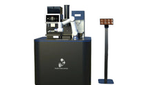 Load image into Gallery viewer, The Single-Arm Robotic Coffee Station by Elite Robots (Enclosed or Open-Style) from Useabot features a robotic arm, touchscreen display, and separate small stand for self-service coffee options, all with Useabot branding.
